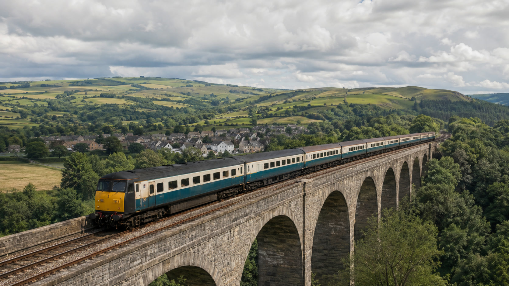 An original passenger train crossing a high viaduct through green countryside
